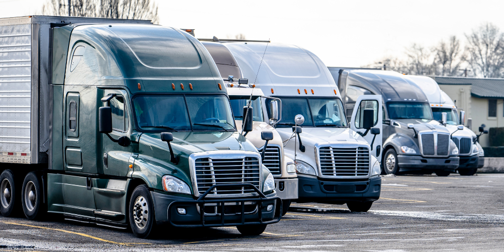 Row of tractor trailers in a parking lot