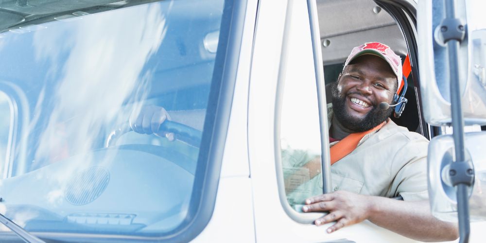 Truck Driver smiling out window of big rig